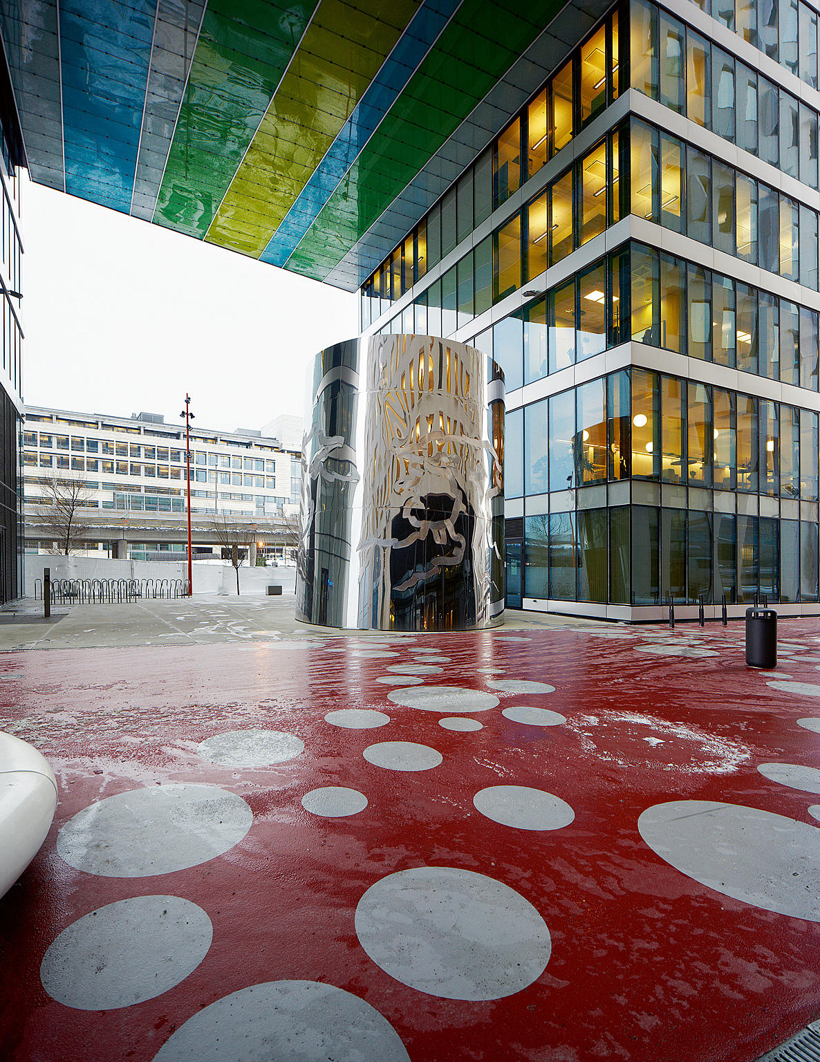 Rommet under PWC-bygget. Utegulvet er dekket med et rødt polyuretanbelegg. Den blanke trommelen er et kunstverk signert den danske kunstneren Erik August Frandsen. Foto: Ivan Brodey